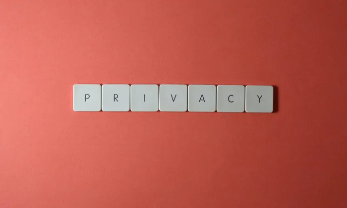 Professional content creator working on laptop with privacy protection interface displayed on screen