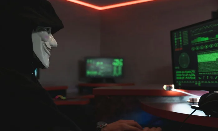Professional content creator working on laptop with security icons and protection symbols overlaid